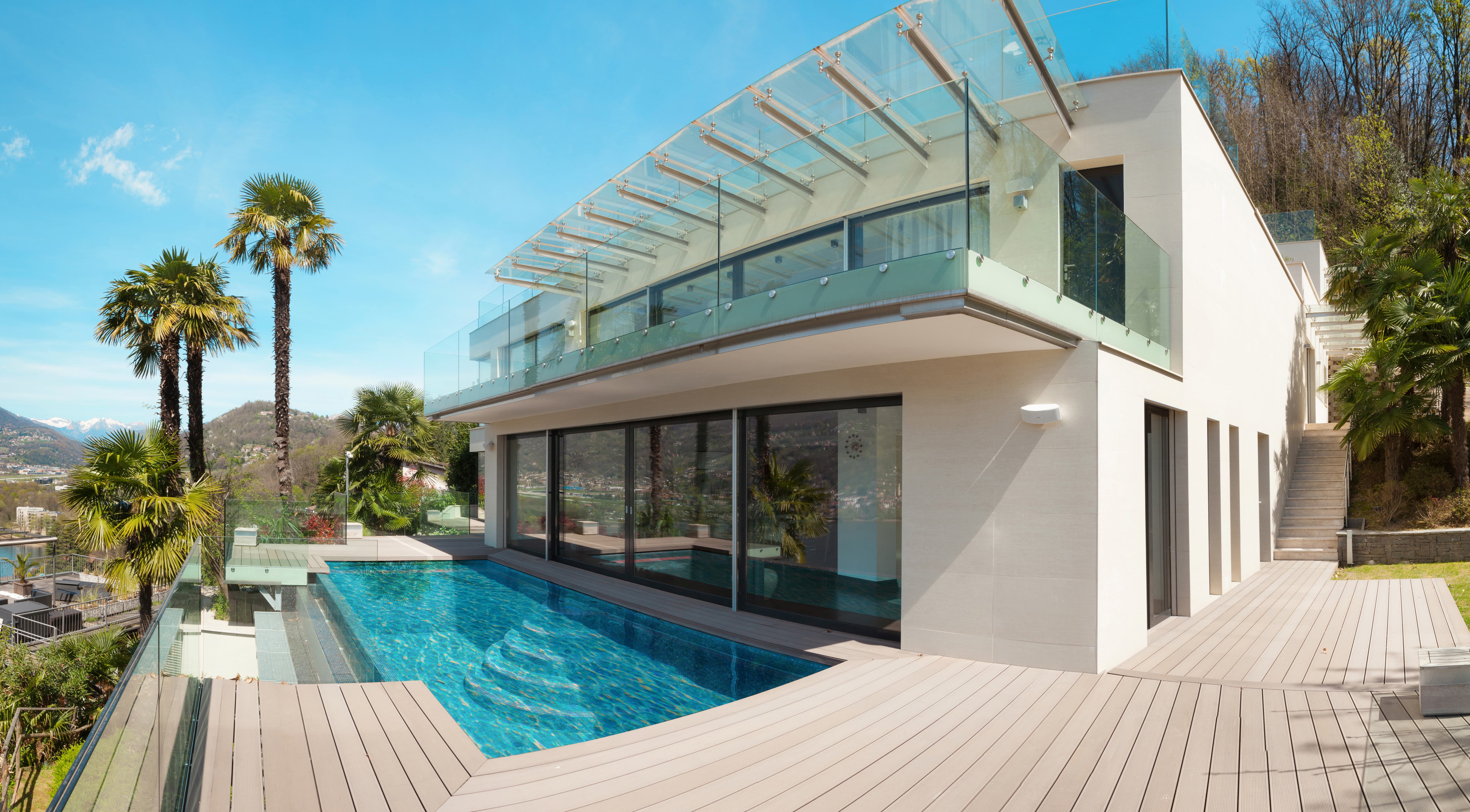 An Artform Collective frameless glass balustrade around a balcony above a pool.