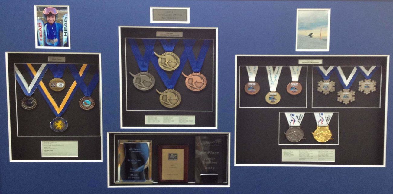 Several trophies and award memorabilia framing by Artform Collective.